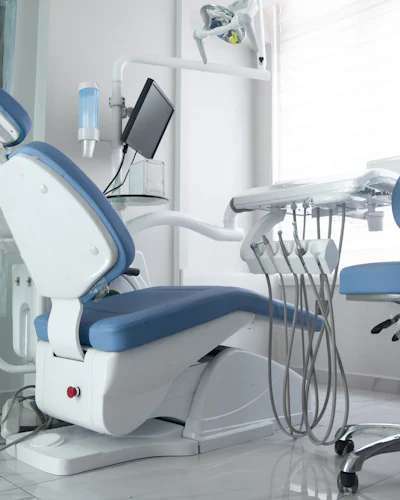 A dental chair and instrument arms up close