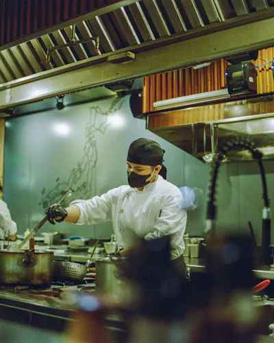 Cooks working a busy commercial kitchen line
